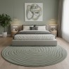 Modern round rug with a fluid relief and overlapping organic lines