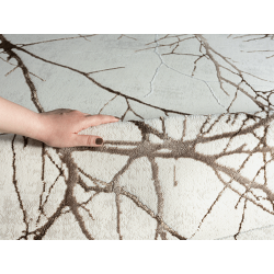 Modern grey rug with abstract branch pattern and marble effect