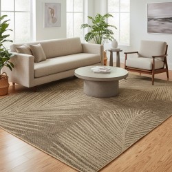 Flat woven indoor/outdoor rug with tropical leaf pattern, durable and easy to clean.