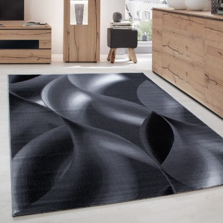 Alfombra de salón de diseño moderno con estampado de ondas de pelo corto, en negro y gris.